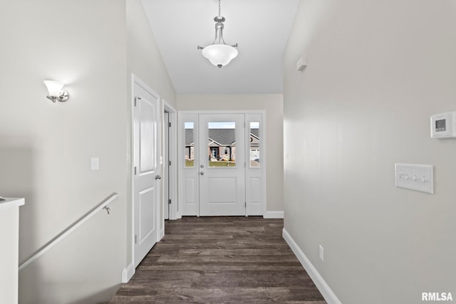 entryway with dark wood-type flooring and lofted ceiling