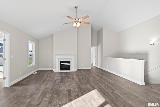 unfurnished living room featuring dark hardwood / wood-style floors, high vaulted ceiling, and ceiling fan