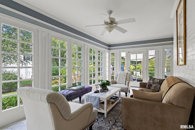 sunroom / solarium featuring a wealth of natural light and ceiling fan