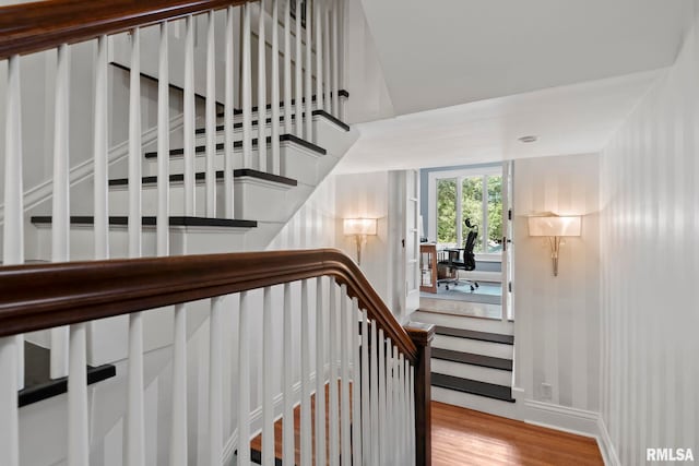 stairs with hardwood / wood-style flooring