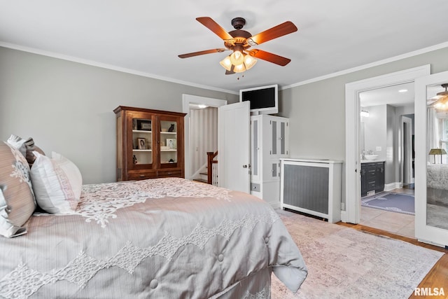 bedroom with crown molding, connected bathroom, ceiling fan, and light hardwood / wood-style floors