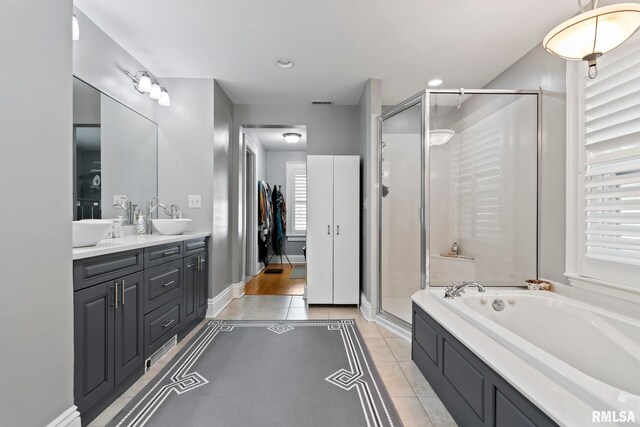 bathroom featuring vanity, tile patterned floors, and plus walk in shower