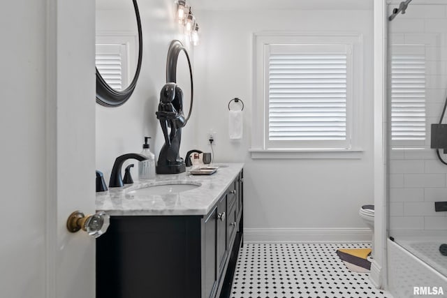 full bathroom with vanity, toilet, and baseboards