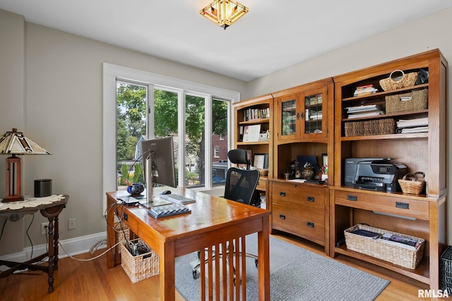 home office featuring baseboards and wood finished floors