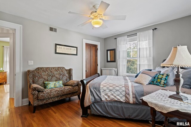 bedroom with wood-type flooring and ceiling fan