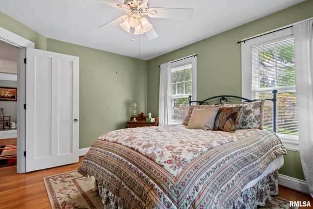 bedroom with light hardwood / wood-style flooring and ceiling fan