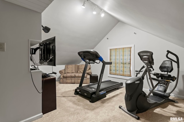 exercise room with vaulted ceiling and carpet