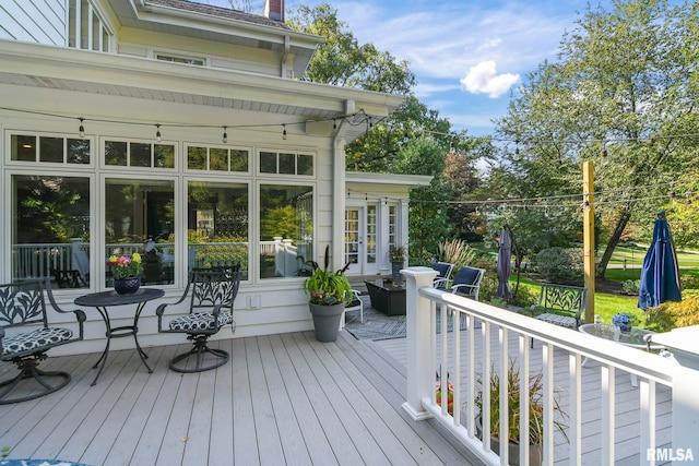 wooden terrace featuring a sunroom