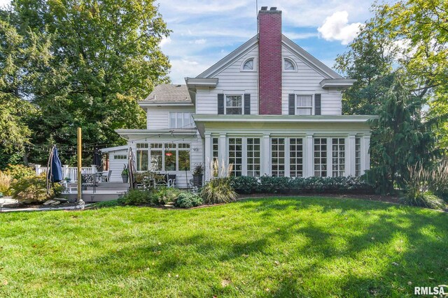 back of house with a yard and a wooden deck