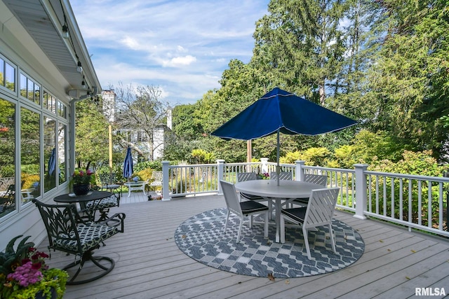 wooden terrace featuring outdoor dining space