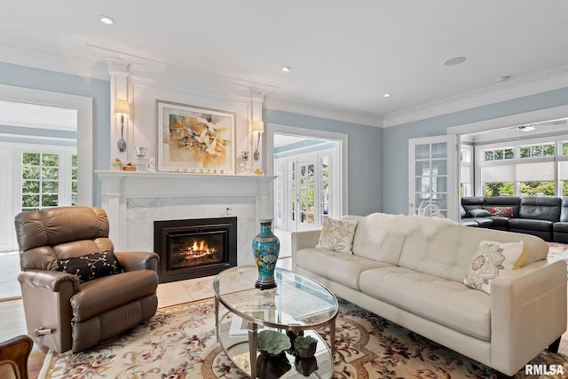 living room with a premium fireplace, recessed lighting, and ornamental molding