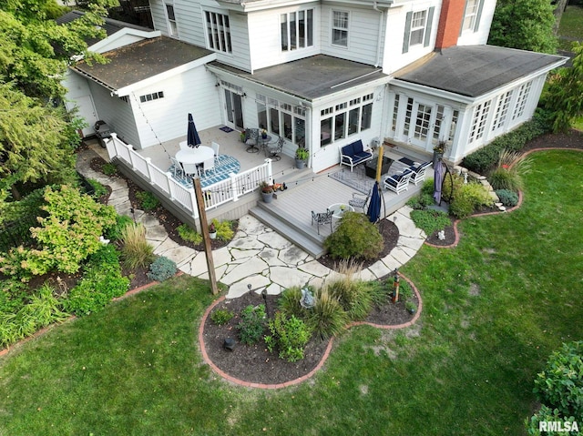 rear view of property with a wooden deck, a yard, and a patio