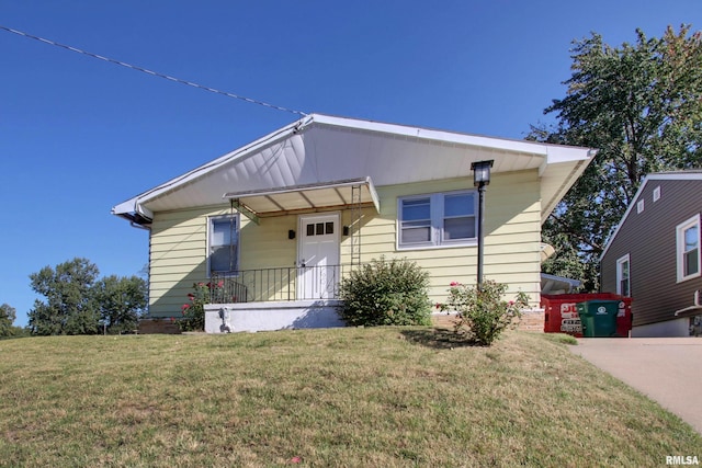 bungalow-style house featuring a front yard