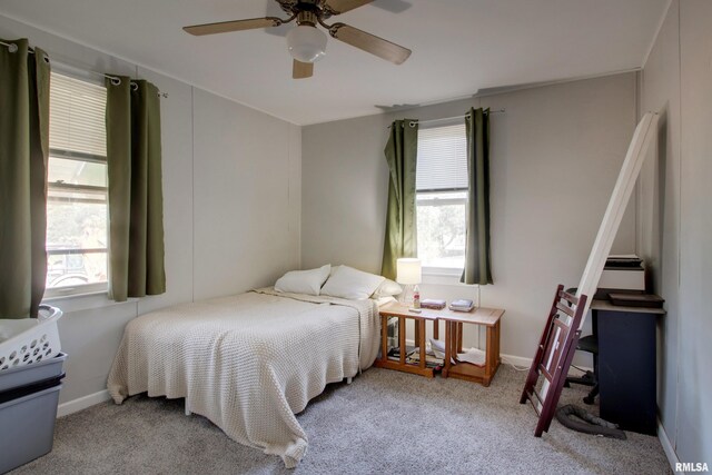 bedroom featuring light colored carpet and ceiling fan