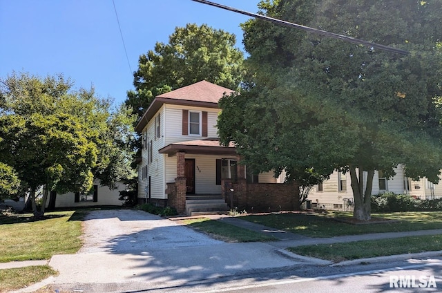 view of front facade with a porch and a front lawn