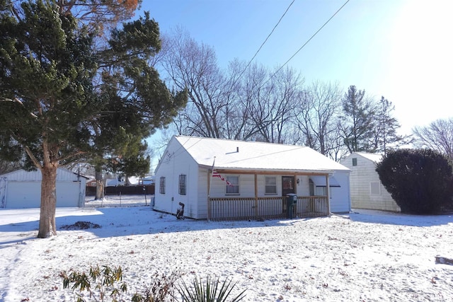 view of front of house featuring a garage and an outbuilding