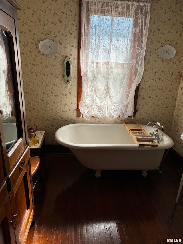 bathroom with hardwood / wood-style floors and a bathing tub