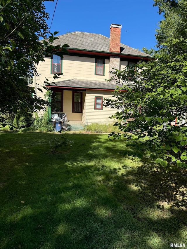 rear view of house with a yard