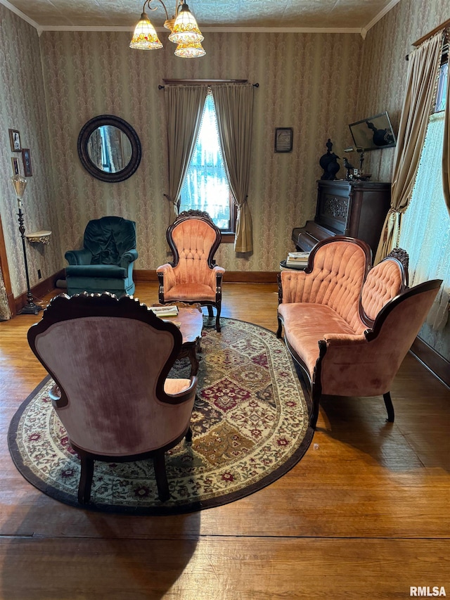 living room with ornamental molding, hardwood / wood-style floors, and a chandelier