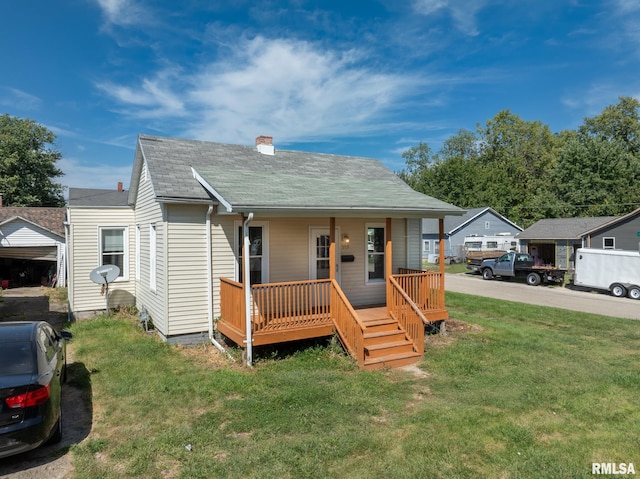 bungalow-style home with covered porch and a front lawn