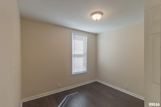 spare room with dark hardwood / wood-style flooring