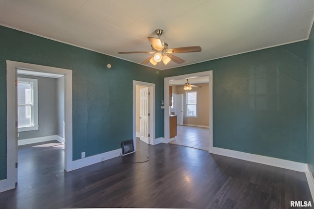 spare room featuring ceiling fan and dark hardwood / wood-style floors