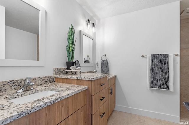 bathroom featuring vanity, a textured ceiling, and tile patterned flooring