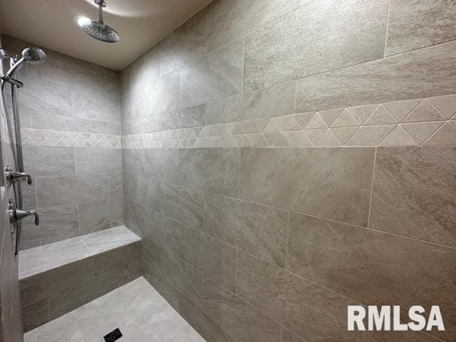 bathroom with tiled shower