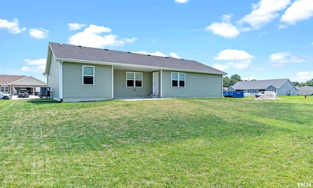 rear view of property featuring a lawn, a patio, and central AC unit