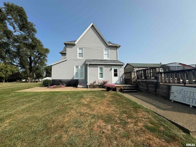 view of front facade with a deck and a front lawn