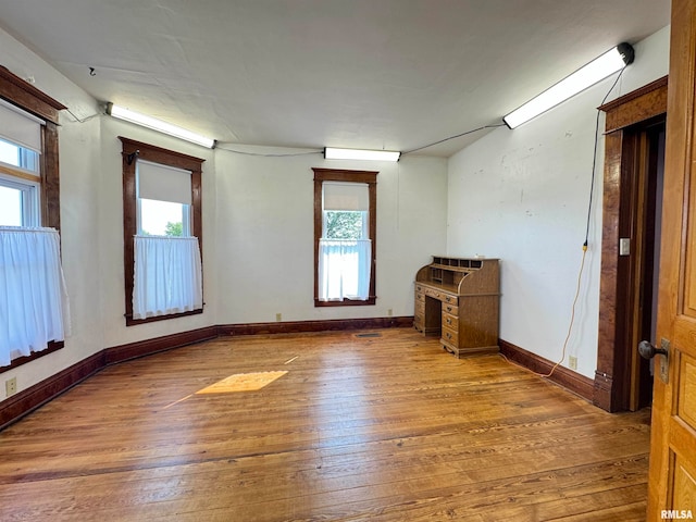 unfurnished room with wood-type flooring