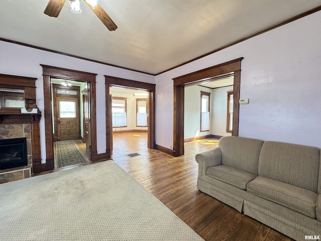 1677 E Smokey Rd, Avon, IL 61415 - living room with ceiling fan, a fireplace, crown molding, and wood-type flooring