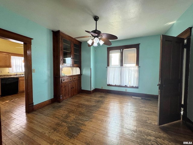 interior space with a healthy amount of sunlight, ceiling fan, dark hardwood / wood-style floors, and sink