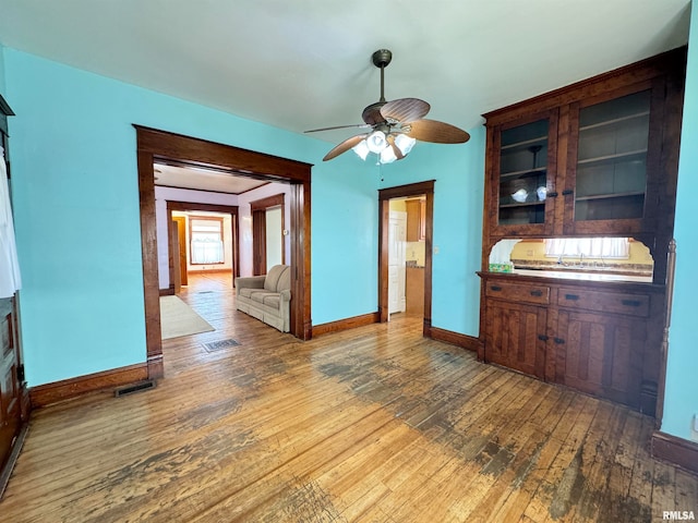 unfurnished dining area featuring hardwood / wood-style flooring and ceiling fan