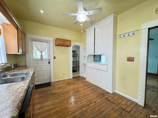 kitchen with dark hardwood / wood-style flooring, dishwasher, sink, white cabinetry, and ceiling fan