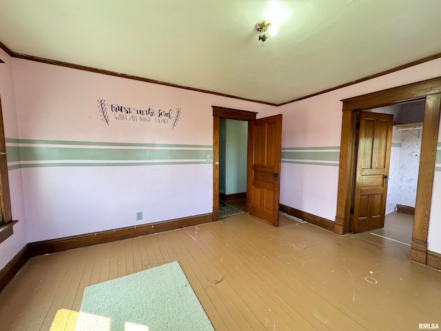 unfurnished bedroom with ornamental molding and wood-type flooring