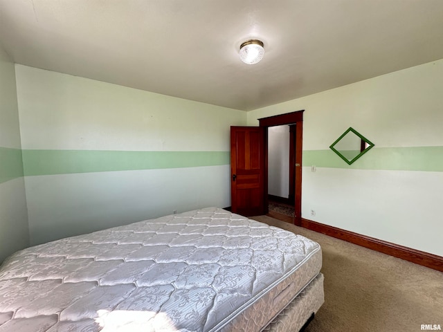 bedroom with lofted ceiling and carpet floors