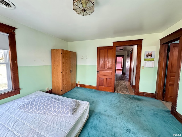 carpeted bedroom with vaulted ceiling