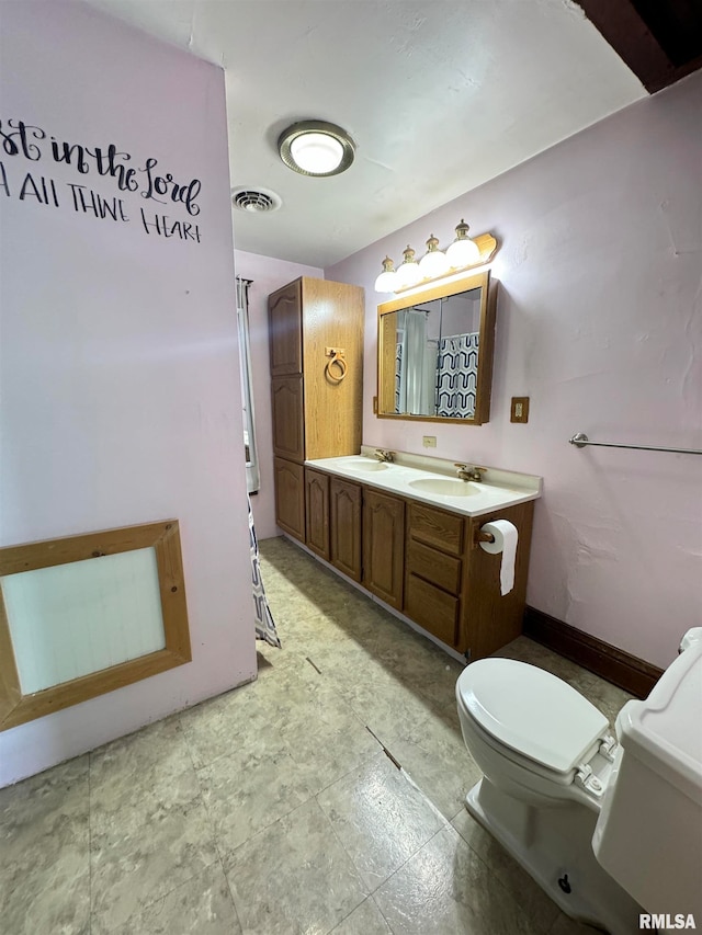 bathroom featuring toilet and vanity