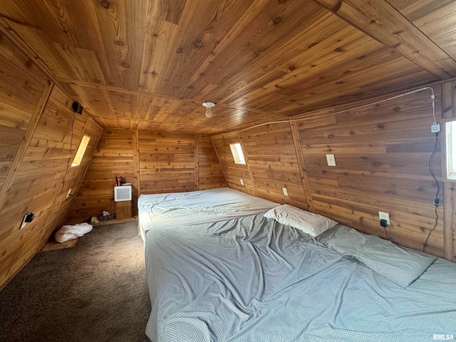 unfurnished bedroom featuring lofted ceiling, wood walls, wood ceiling, and carpet