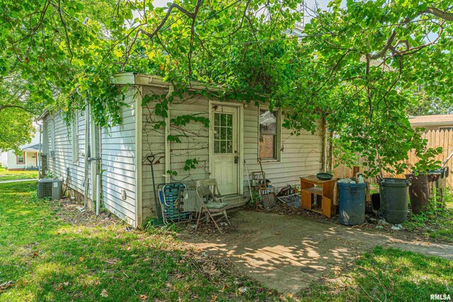 rear view of property featuring central AC