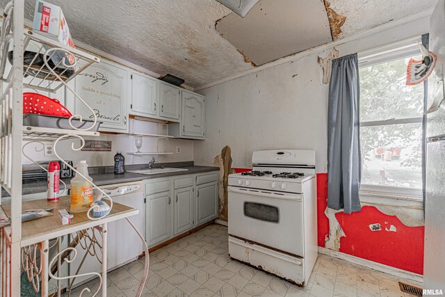 kitchen with white cabinets, white appliances, a textured ceiling, and sink