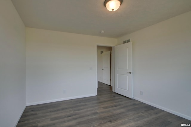 unfurnished room featuring dark hardwood / wood-style flooring