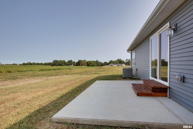 view of patio featuring central AC and a rural view