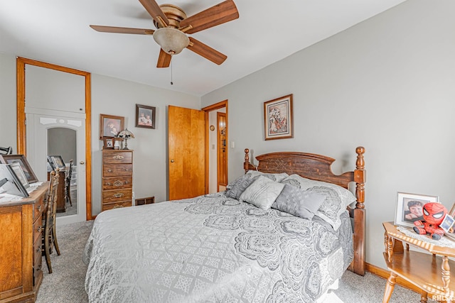 bedroom with ceiling fan and light carpet