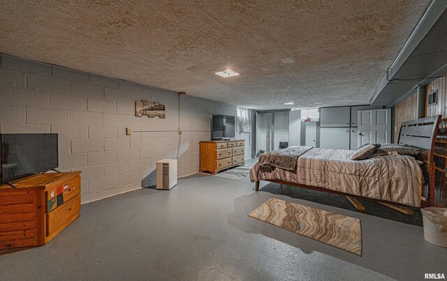 bedroom featuring a textured ceiling and concrete flooring