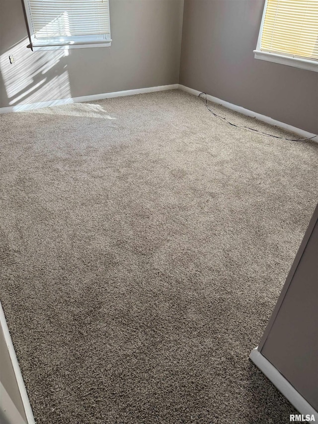 carpeted spare room with a healthy amount of sunlight