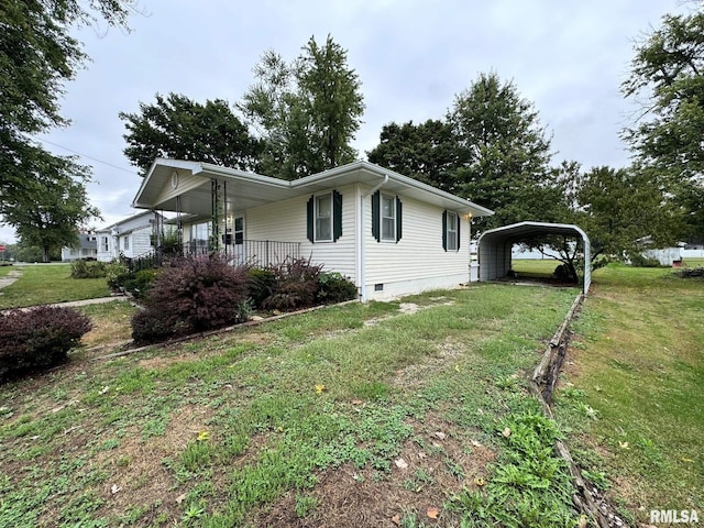 view of property exterior with a yard, covered porch, and a carport