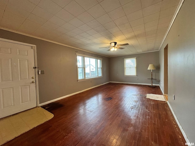 empty room featuring ornamental molding, dark hardwood / wood-style floors, and ceiling fan