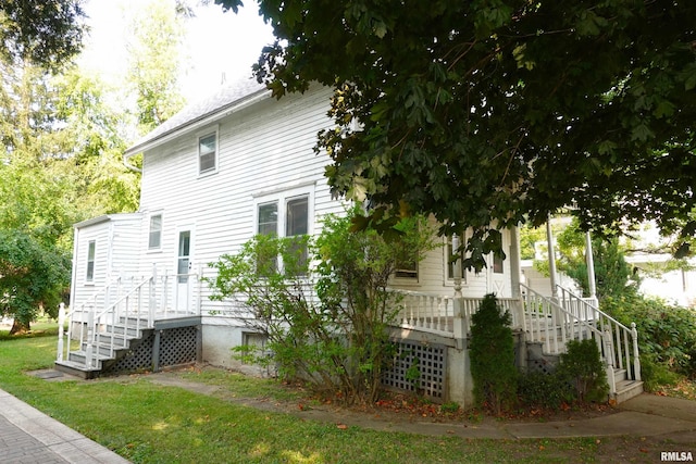 view of property exterior featuring a lawn